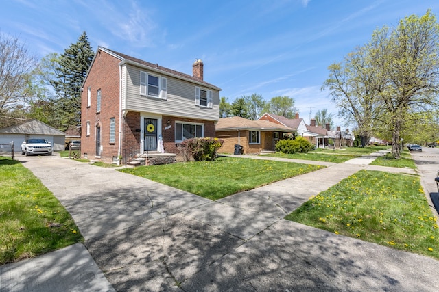 view of front of house featuring a chimney, brick siding, an outbuilding, a front yard, and a garage
