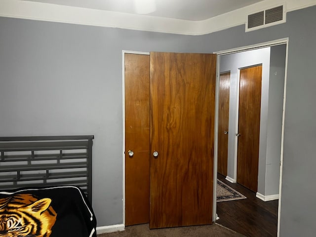 bedroom with baseboards and wood finished floors