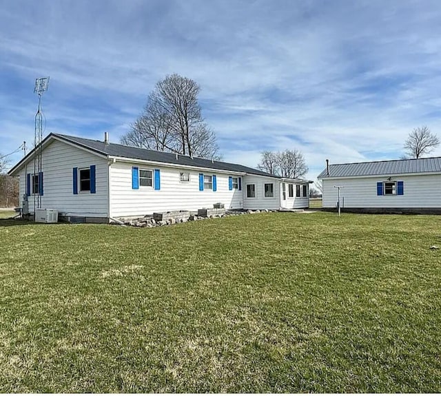 31915 M 60, Leonidas, MI 49066 - back of house featuring a yard and central air condition unit