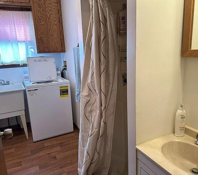 31915 M 60, Leonidas, MI 49066 - washroom featuring wood finished floors, a sink, and washer / dryer
