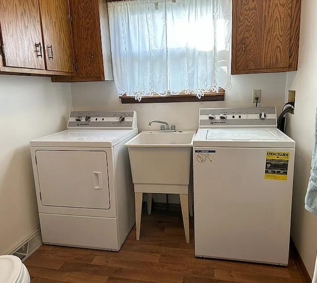 31915 M 60, Leonidas, MI 49066 - washroom featuring washing machine and clothes dryer, cabinet space, and wood finished floors