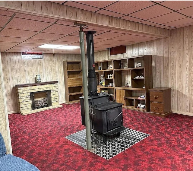 31915 M 60, Leonidas, MI 49066 - living area with a wood stove, carpet floors, wooden walls, a drop ceiling, and a fireplace