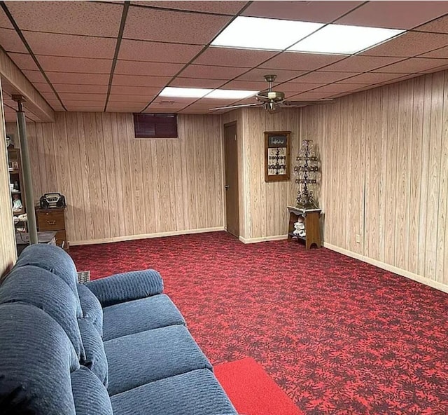 31915 M 60, Leonidas, MI 49066 - carpeted living area with ceiling fan, a paneled ceiling, wooden walls, and baseboards