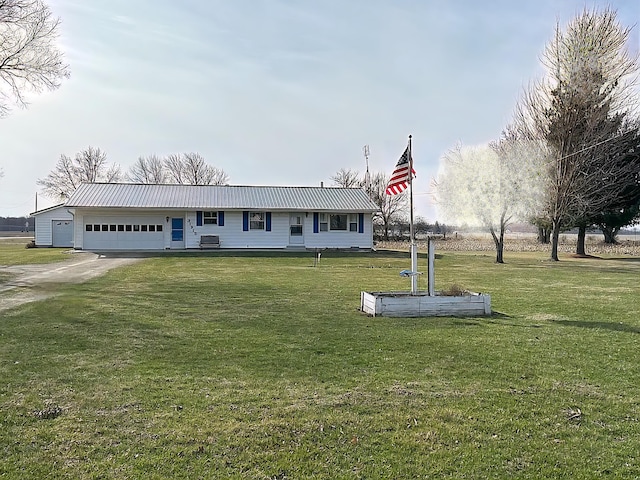 31915 M 60, Leonidas, MI 49066 - view of front of property featuring a front lawn, a garage, metal roof, and driveway