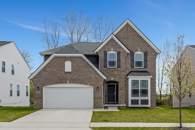 traditional-style house with a front yard, brick siding, concrete driveway, a garage, and a shingled roof