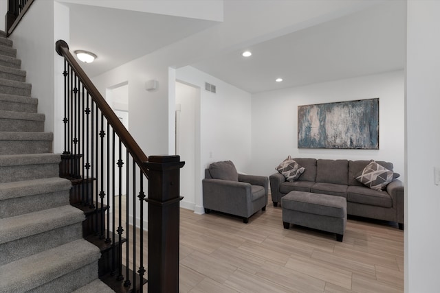 living room with recessed lighting, stairs, and baseboards