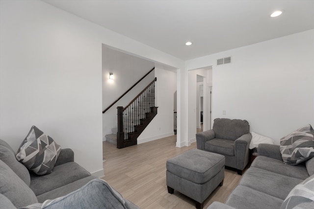 living area with stairway, light wood-type flooring, recessed lighting, and baseboards