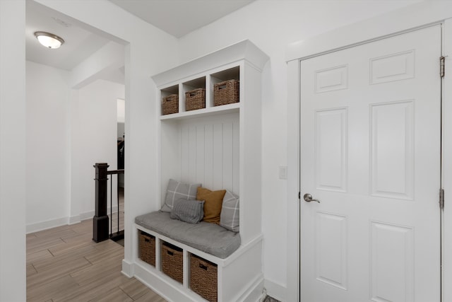 mudroom featuring light wood finished floors and baseboards