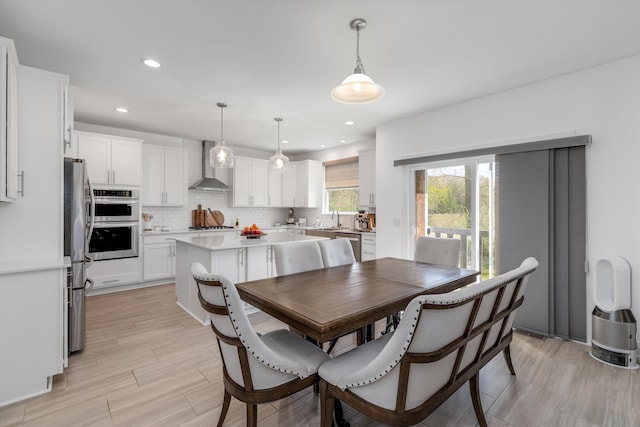 dining room featuring recessed lighting and light wood finished floors