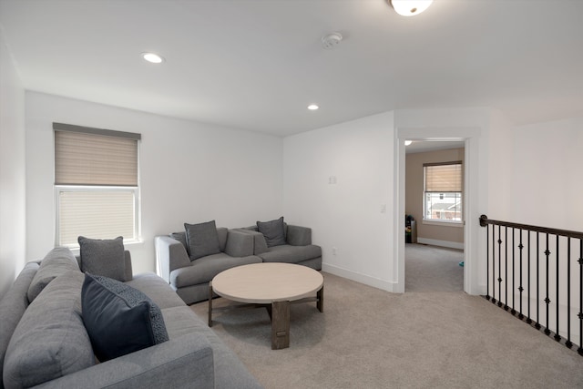 living area with baseboards, light colored carpet, and recessed lighting