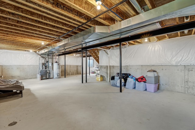 unfinished basement featuring gas water heater