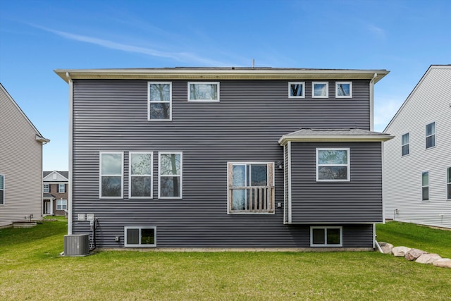 back of house featuring a yard and central air condition unit