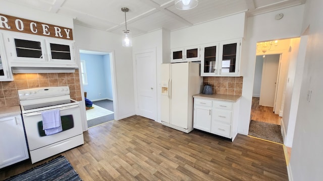 kitchen featuring white appliances, wood finished floors, light countertops, white cabinets, and beam ceiling
