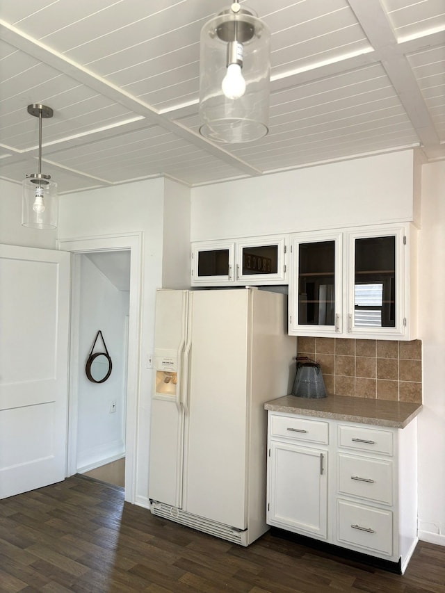 kitchen with white refrigerator with ice dispenser, white cabinets, decorative backsplash, and dark wood finished floors