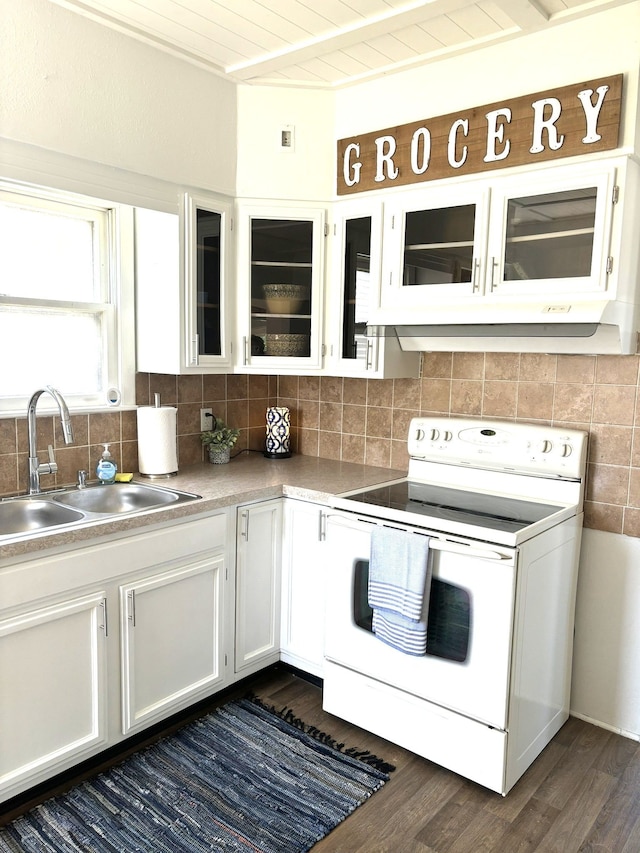 kitchen with white electric range, a sink, white cabinets, dark wood finished floors, and tasteful backsplash