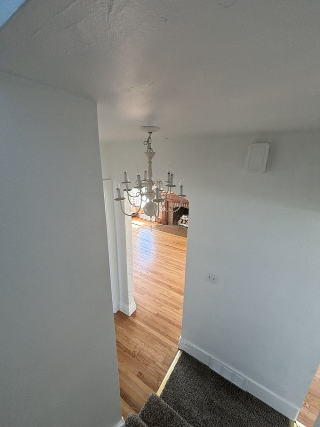 1040 Ronald St, Flint, MI 48507 - dining space with wood finished floors, a chandelier, and baseboards