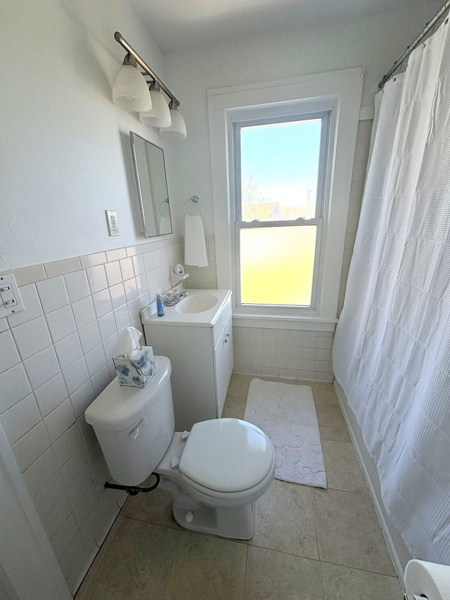 bathroom featuring toilet, tile patterned flooring, tile walls, vanity, and a shower with shower curtain