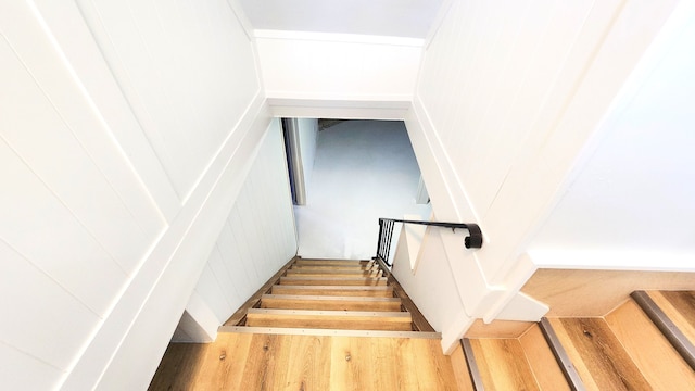 stairs featuring wood finished floors