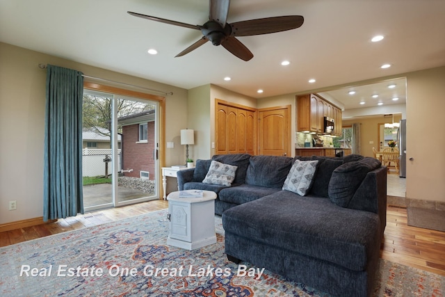 1416 Airfield Ln, Midland, MI 48642 - living room with light wood-style flooring, ceiling fan, recessed lighting, and baseboards