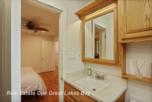 1416 Airfield Ln, Midland, MI 48642 - bathroom with a ceiling fan, vanity, and wood finished floors