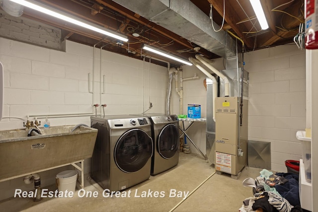 1416 Airfield Ln, Midland, MI 48642 - washroom with washing machine and clothes dryer, heating unit, and concrete block wall