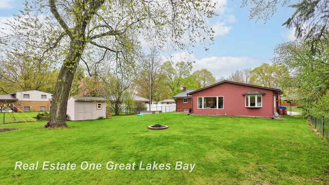 1416 Airfield Ln, Midland, MI 48642 - view of yard featuring an outdoor fire pit, a shed, and an outdoor structure