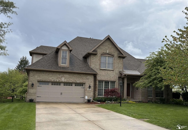 traditional-style house with brick siding, a front yard, and concrete driveway