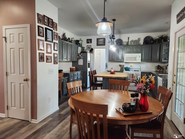 dining room with dark wood-style flooring and baseboards