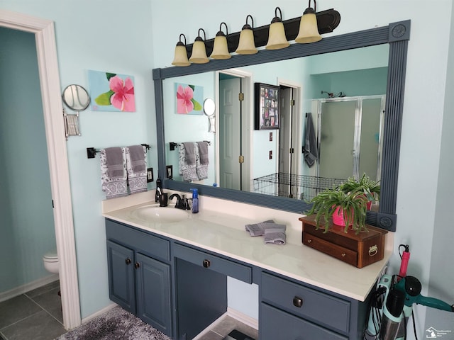 912 Kings Park Rd, Monroe, MI 48161 - bathroom featuring a stall shower, vanity, toilet, baseboards, and tile patterned flooring