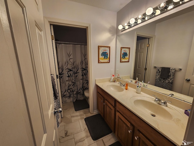 912 Kings Park Rd, Monroe, MI 48161 - bathroom with marble finish floors, double vanity, and toilet