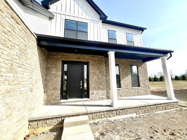 20846 Farrier Pl, Northville, MI 48167 - doorway to property featuring covered porch and board and batten siding