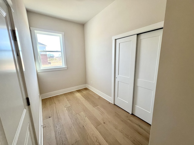 20846 Farrier Pl, Northville, MI 48167 - unfurnished bedroom with light wood-style flooring, baseboards, and a closet