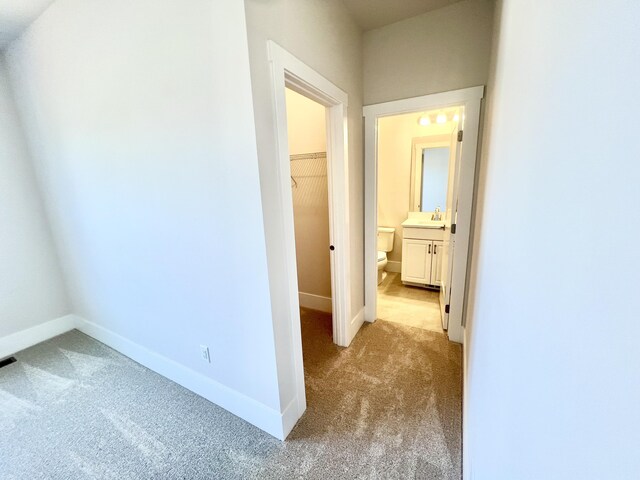 20846 Farrier Pl, Northville, MI 48167 - corridor featuring light carpet, a sink, and baseboards