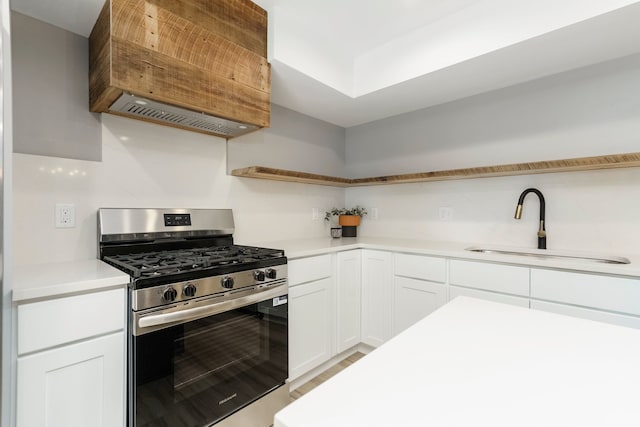 3246 Millwall Ave, Keego Harbor, MI 48320 - kitchen with stainless steel gas stove, open shelves, a sink, and white cabinets