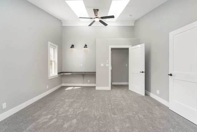 3246 Millwall Ave, Keego Harbor, MI 48320 - unfurnished bedroom with a skylight, carpet flooring, baseboards, and a ceiling fan