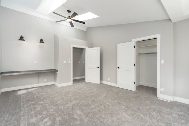 3246 Millwall Ave, Keego Harbor, MI 48320 - unfurnished bedroom with a skylight, vaulted ceiling, carpet floors, baseboards, and a ceiling fan