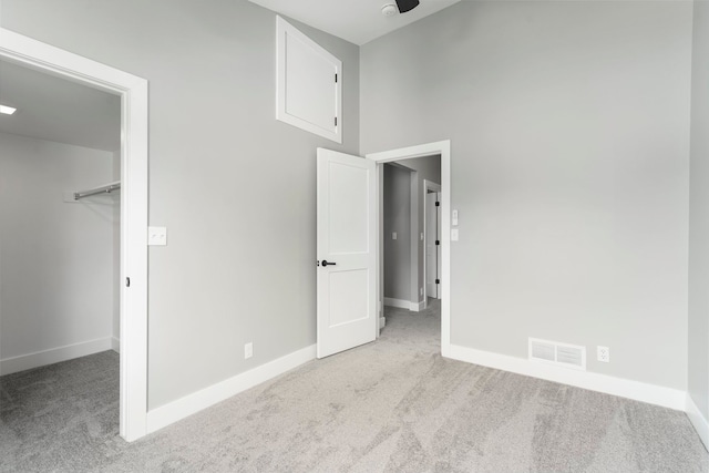 3246 Millwall Ave, Keego Harbor, MI 48320 - unfurnished bedroom featuring carpet floors, a walk in closet, and baseboards