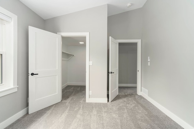 3246 Millwall Ave, Keego Harbor, MI 48320 - unfurnished bedroom featuring a spacious closet, carpet flooring, baseboards, and a closet