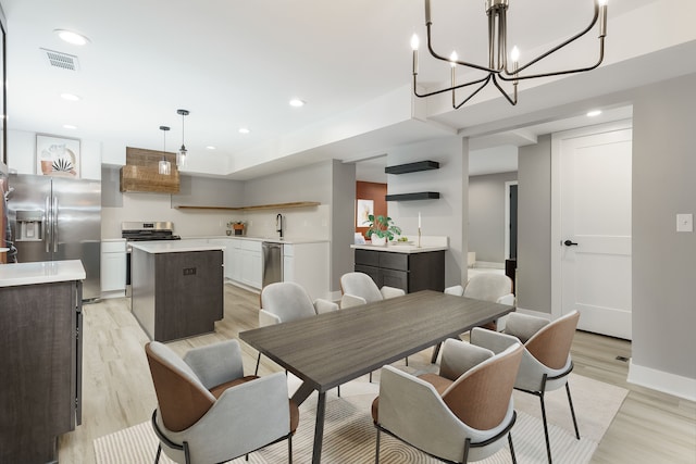 3246 Millwall Ave, Keego Harbor, MI 48320 - dining room with light wood-style flooring, a chandelier, recessed lighting, and baseboards
