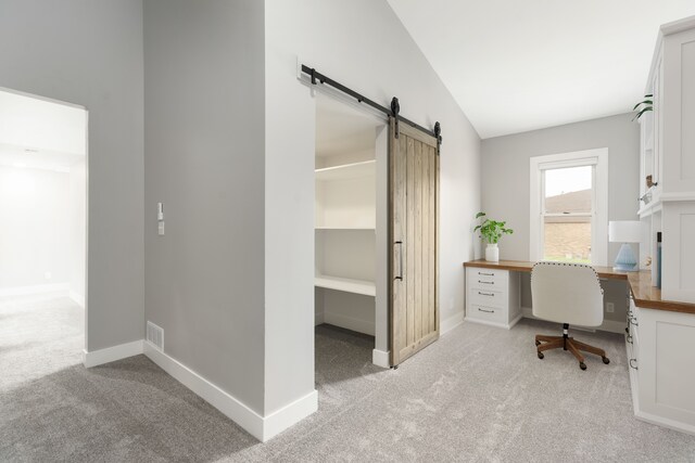 3246 Millwall Ave, Keego Harbor, MI 48320 - home office with light colored carpet, vaulted ceiling, a barn door, and baseboards