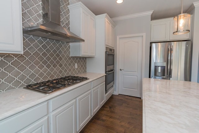 kitchen featuring stainless steel appliances, wall chimney exhaust hood, crown molding, white cabinetry, and dark wood-style floors