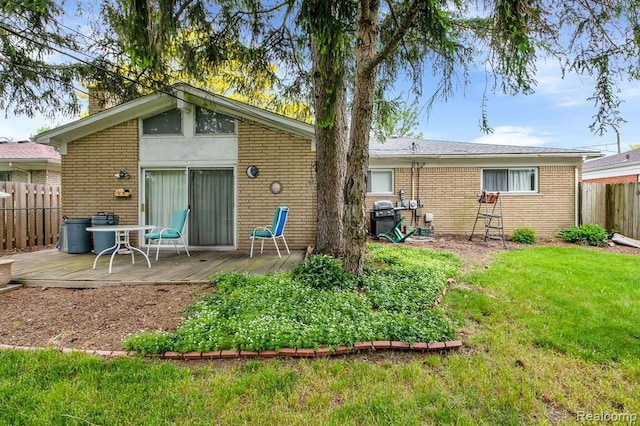 rear view of house with brick siding and a deck