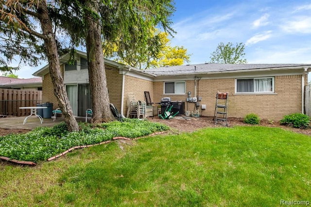 rear view of house featuring brick siding and a patio