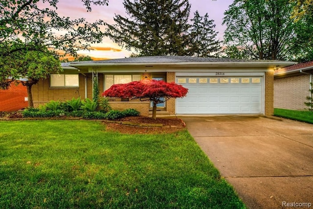 single story home featuring concrete driveway, brick siding, a garage, and a lawn
