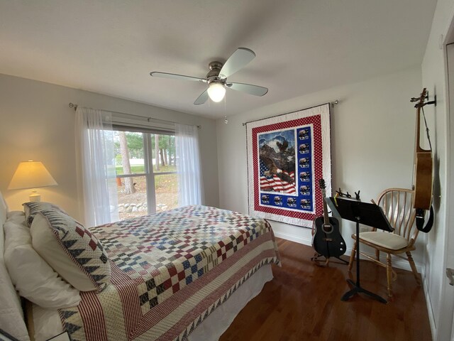 bedroom featuring wood finished floors, baseboards, and a ceiling fan