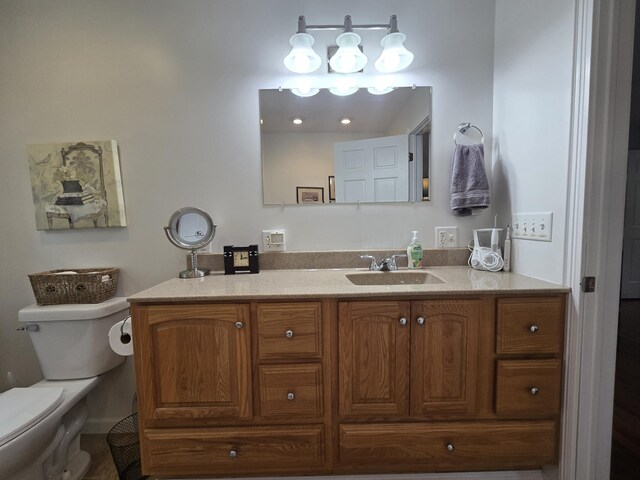 bathroom featuring toilet and vanity