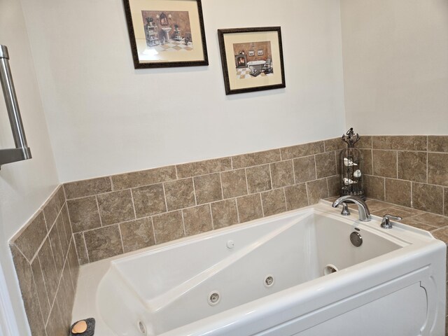 bathroom with a tub with jets