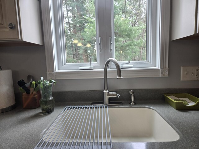 kitchen view of a sink and dark countertops