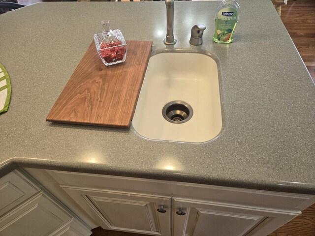 detailed view of a sink and wood finished floors