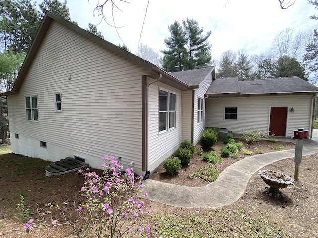 view of home's exterior with a shingled roof